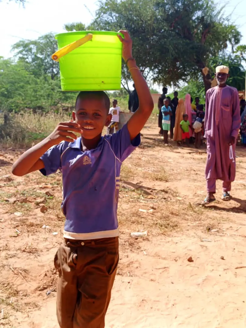 Boy with a water bucket