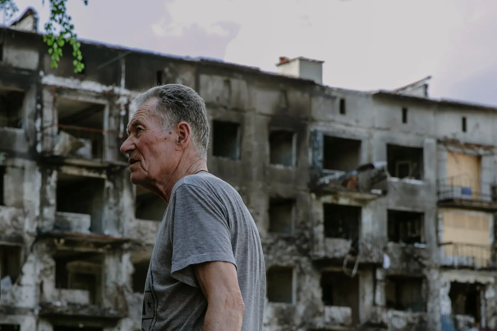 Man in front of a destroyed home in Ukraine