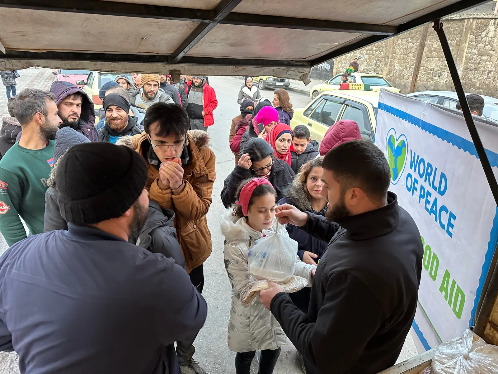 Children at a food distribution in Syria